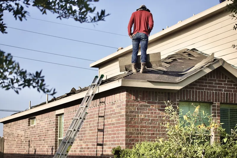 Professional roofer working on a residential roof in Principio Furnace